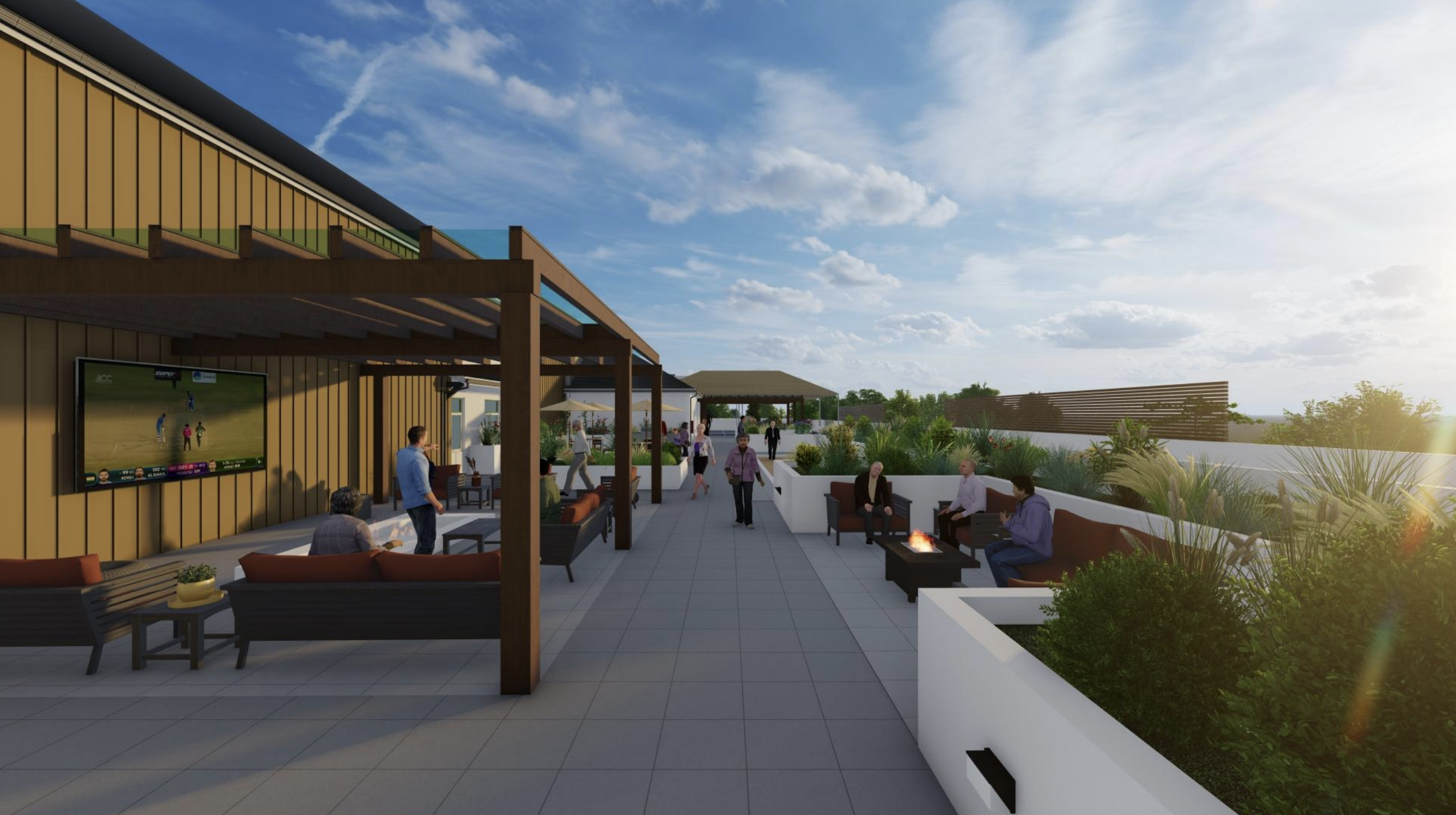 People gather and mingle at couches and tables on a rooftop patio at University Retirement Community